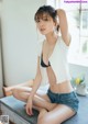 A woman sitting on top of a wooden table.