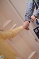 A man and a woman holding hands in front of a door.