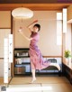 A woman in a purple dress is jumping in the air.