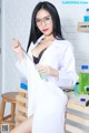 A woman in a lab coat holding a pipe.