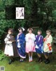 A group of young women dressed in costumes posing for a picture.