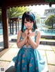 A woman in a blue dress standing in front of a pool.