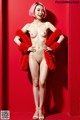 A naked woman in a red fur coat posing for a picture.